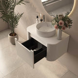 Bathroom vanity with open drawer, sink, and decorative elements.
