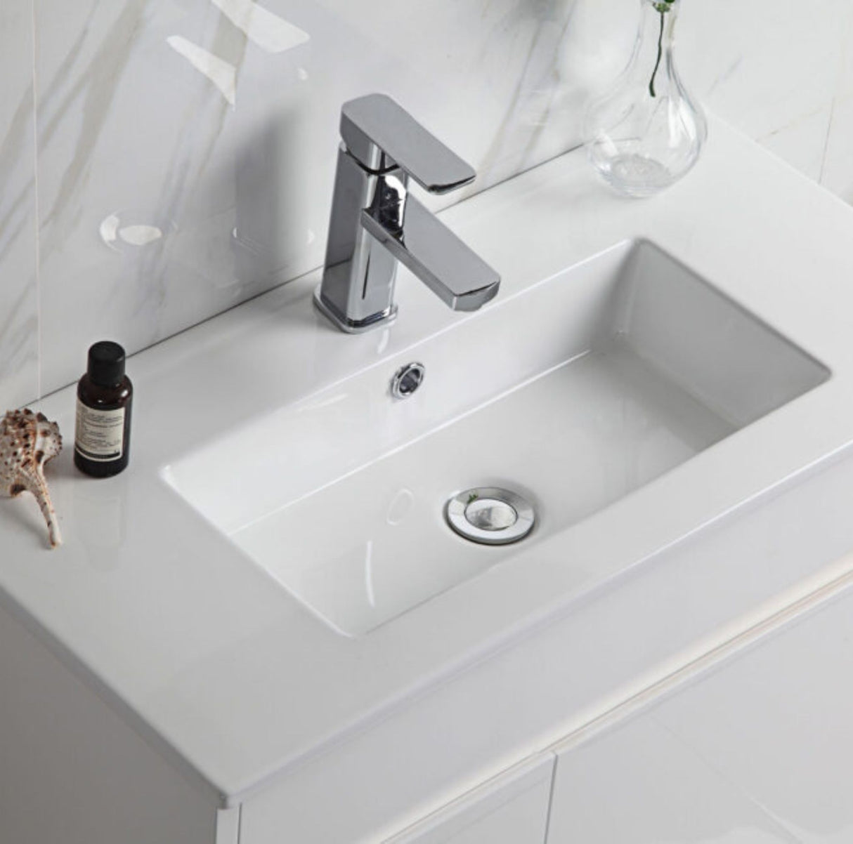 Bathroom sink with chrome faucet on a white countertop