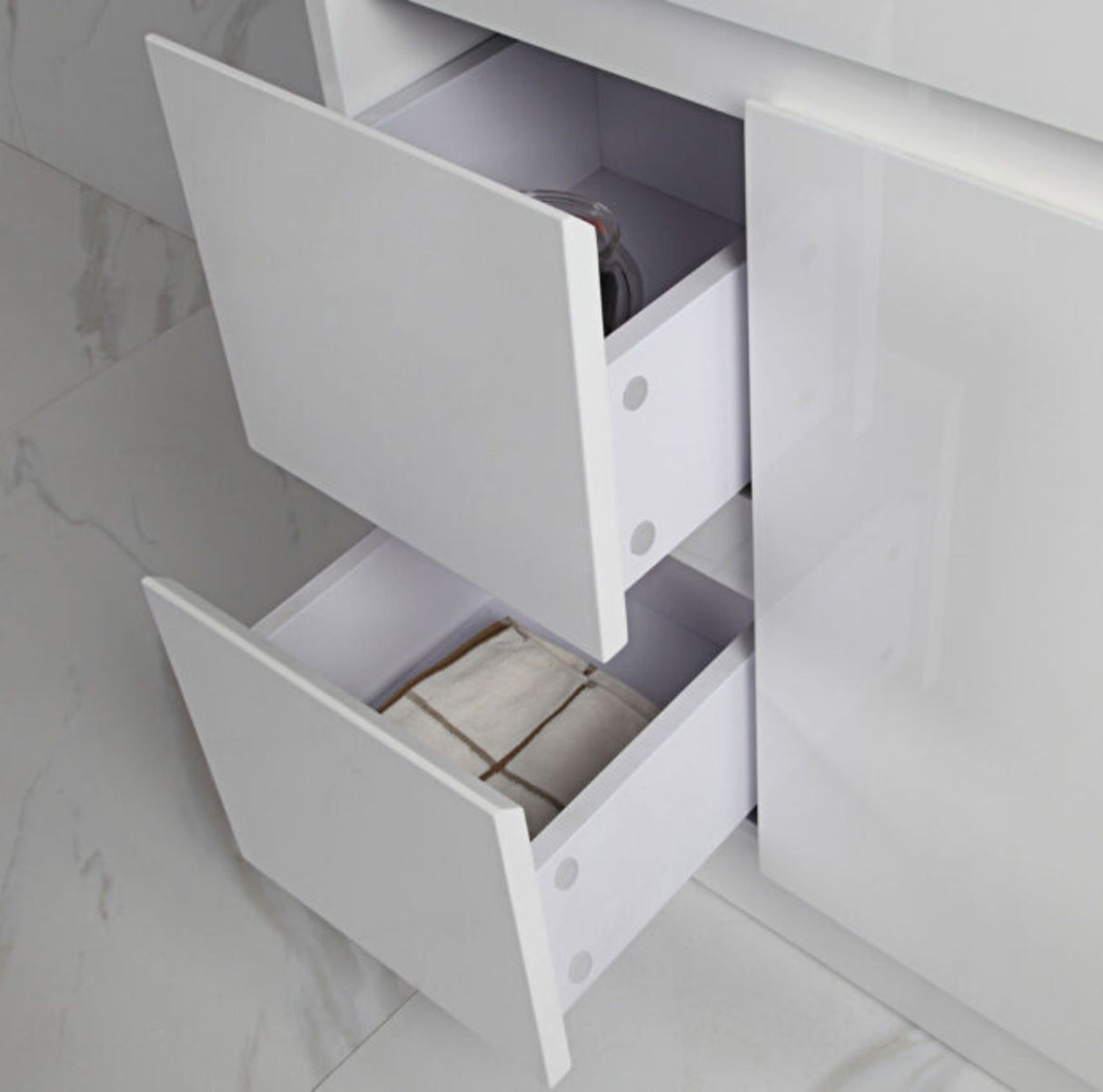 White cabinet with open drawers on a light gray background
