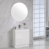 Bathroom vanity with round mirror against a marble wall