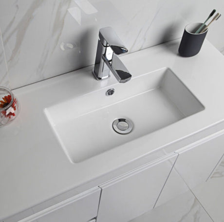 Bathroom sink with faucet and cup holder on a white countertop