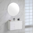 Bathroom with white vanity, round mirror, and marble walls.