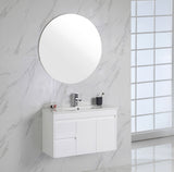 Bathroom with white vanity, round mirror, and marble walls.