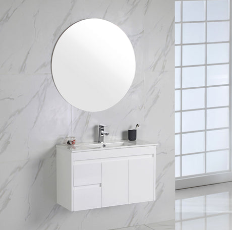 Bathroom with white vanity, round mirror, and marble walls.