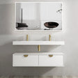 Bathroom vanity with white countertop and gold fixtures, large mirror above.