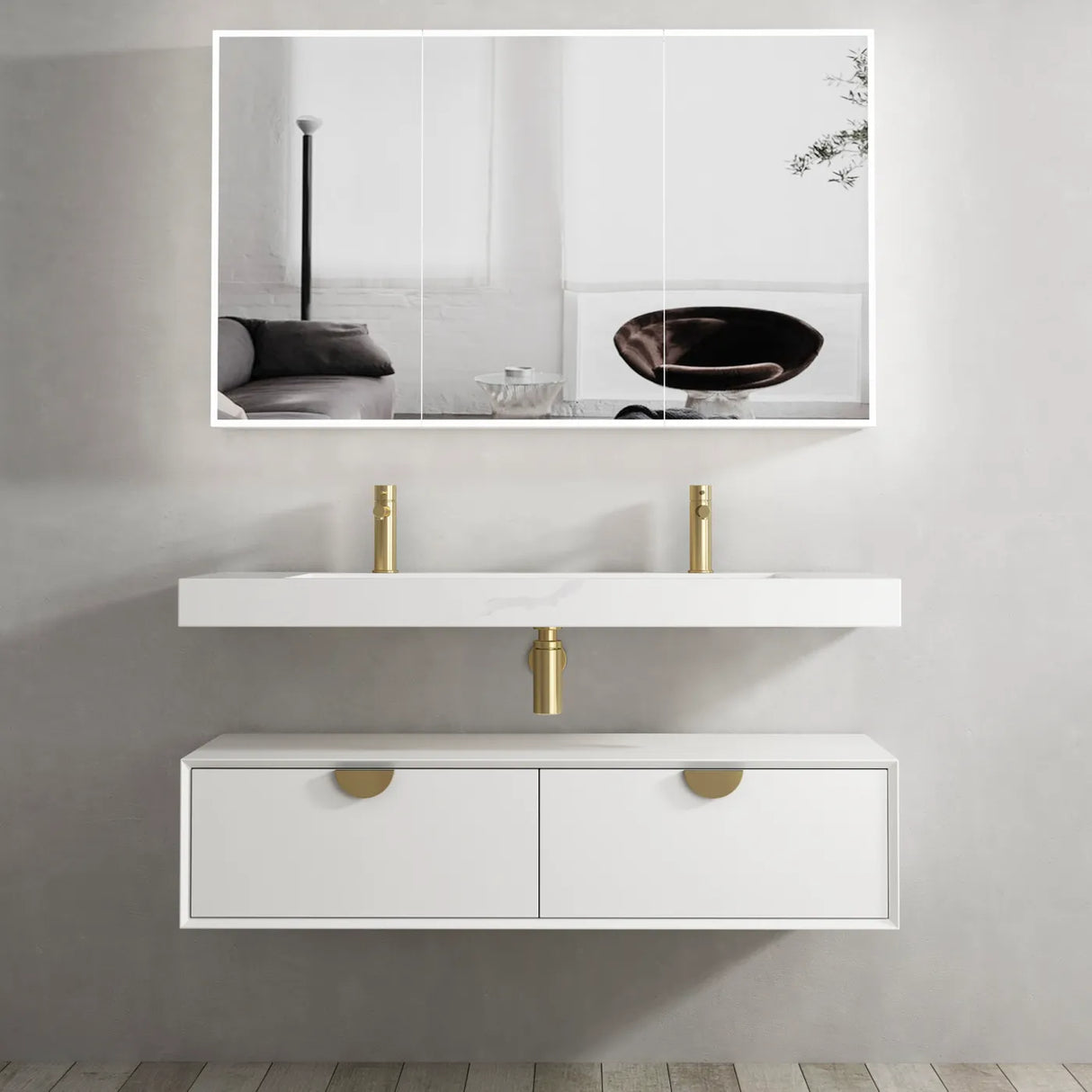 Bathroom vanity with white countertop and gold fixtures, large mirror above.