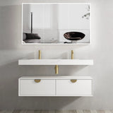 Bathroom vanity with white countertop and gold fixtures, large mirror above.