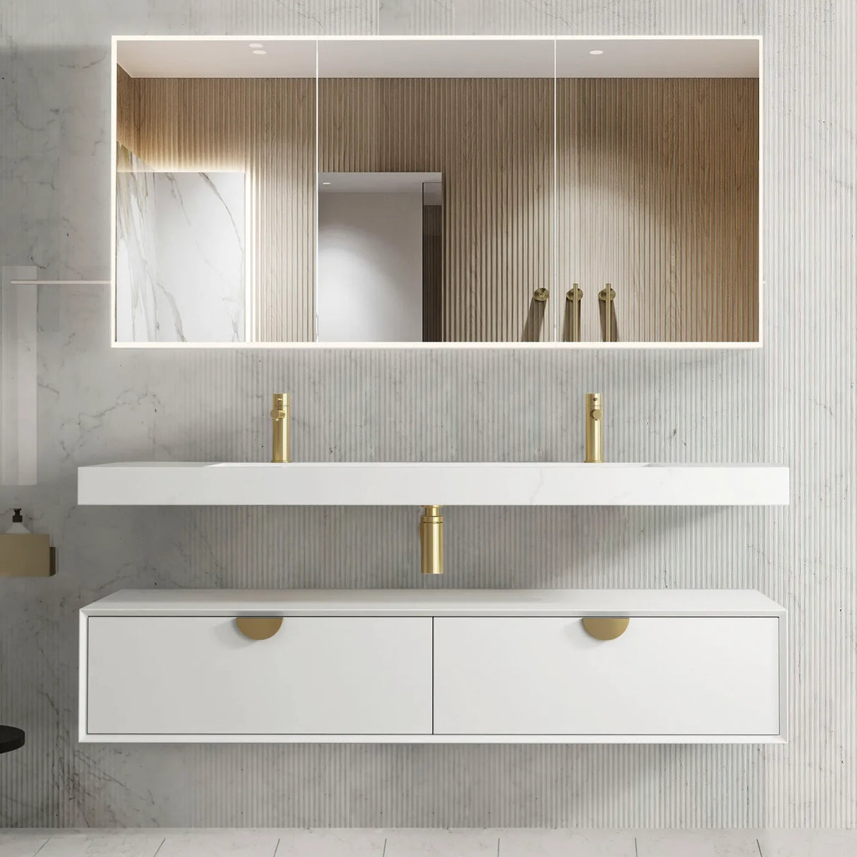 Bathroom vanity with white countertop, gold fixtures, and large mirror on a tiled wall.