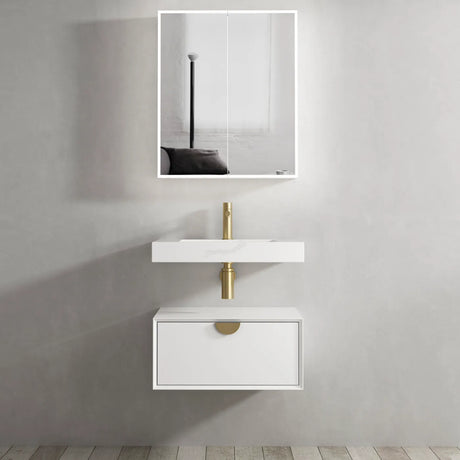 Bathroom vanity with white sink and gold faucet against a gray wall.