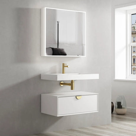 Bathroom vanity with white sink and mirror, gold fixtures, and a window in the background.