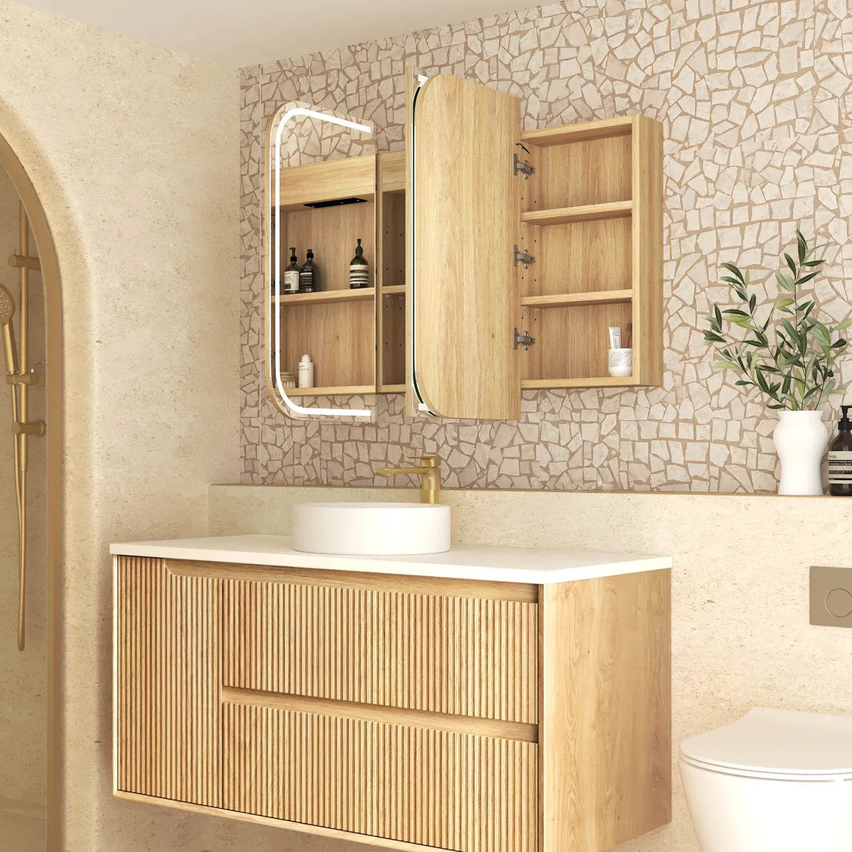 Bathroom with wooden vanity, mirror, and toilet against a stone wall.