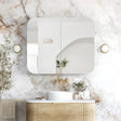 Modern bathroom with marble wall, wooden vanity, and decorative elements.