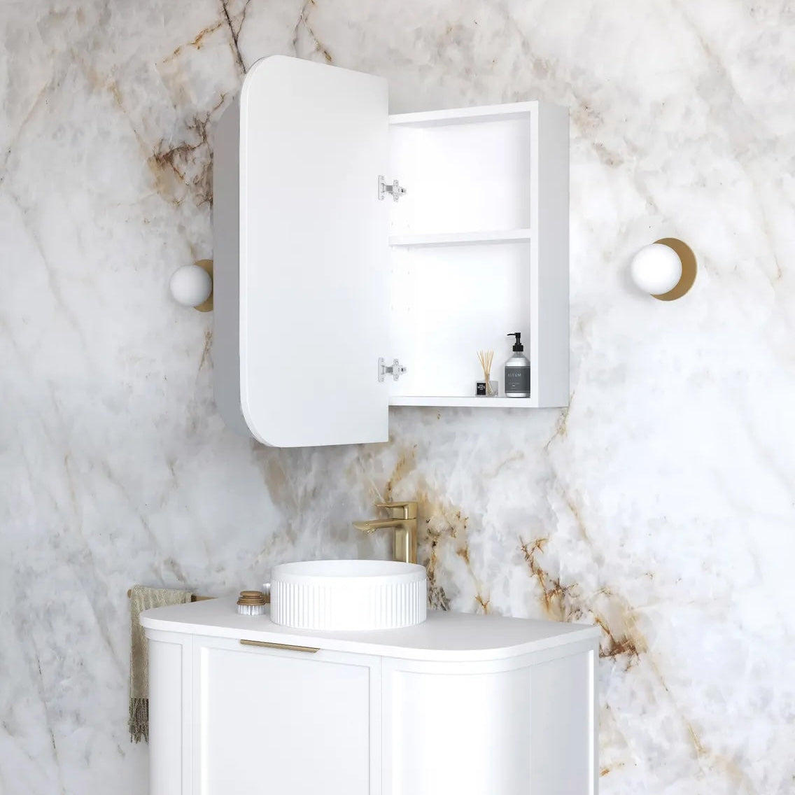 Bathroom with white vanity, sink, and cabinet against a marble wall.