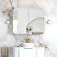 Bathroom with marble wall, white vanity, and gold accents