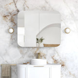 Bathroom with marble wall, white vanity, and gold accents