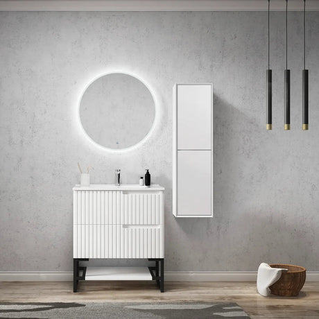 Bathroom with white vanity, round mirror, and cabinet against a gray wall.