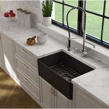 Modern kitchen with a black farmhouse sink and white marble countertops.