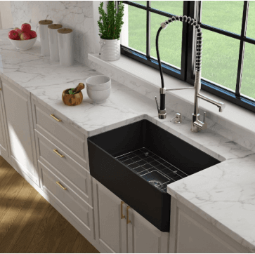 Modern kitchen with a black farmhouse sink and white marble countertops.