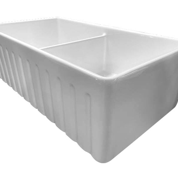White butler sink with ribbed design on a white background
