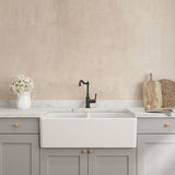 Kitchen sink with gray cabinets and beige wall