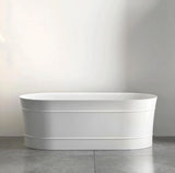 White freestanding bathtub against a plain wall