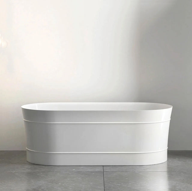White freestanding bathtub against a plain wall