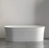 White freestanding bathtub against a gray wall