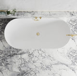 White oval sink with gold fixtures on a marble countertop