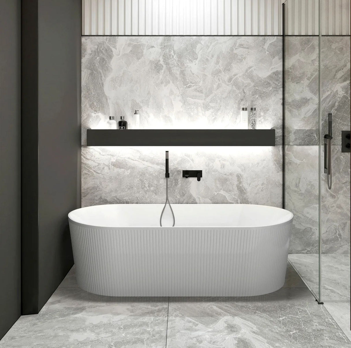 Modern bathroom with a freestanding bathtub against a tiled wall.