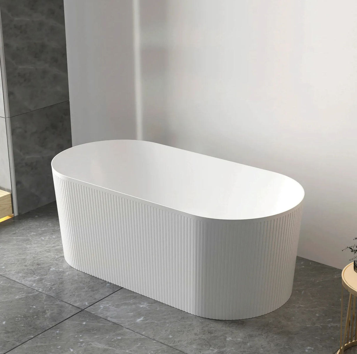 White freestanding bathtub in a modern bathroom setting