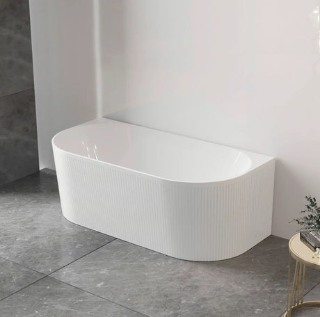 White back to wall bathtub in a modern bathroom setting with gray tiles.