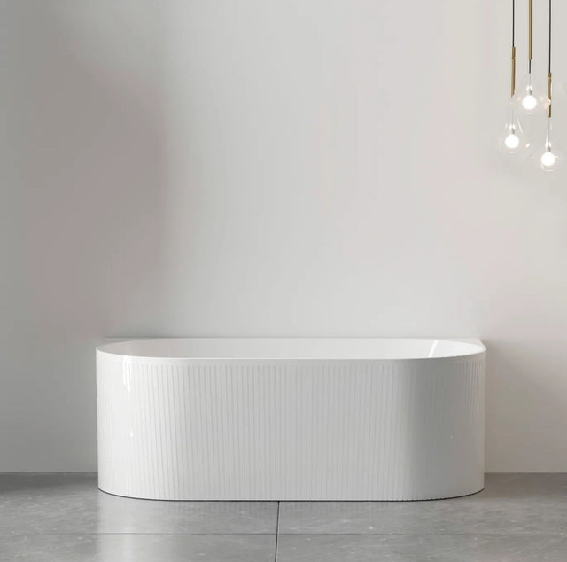 White back to wall bathtub against a plain wall with minimal decor.