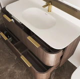 Bathroom vanity with white sink and gold fixtures