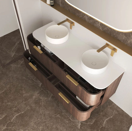 Bathroom vanity with two sinks and gold fixtures on a marble floor.
