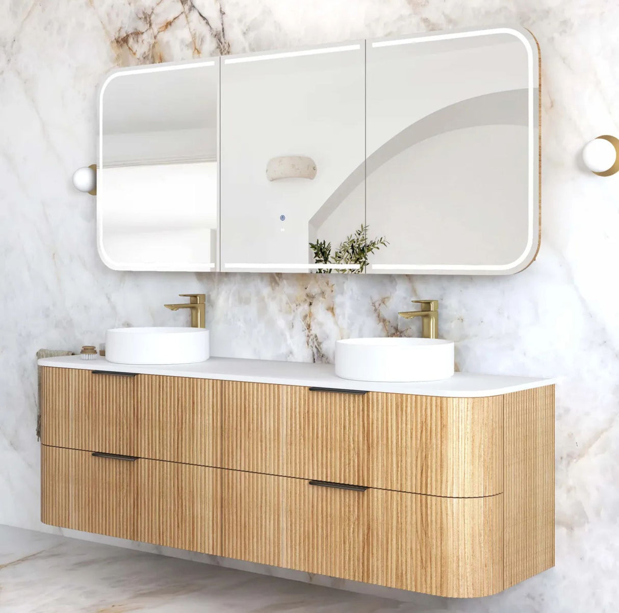 Bathroom vanity with wooden cabinet, white countertop, and three mirrors on a marble wall.