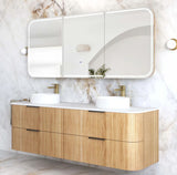 Bathroom vanity with wooden cabinet, white countertop, and three mirrors on a marble wall.
