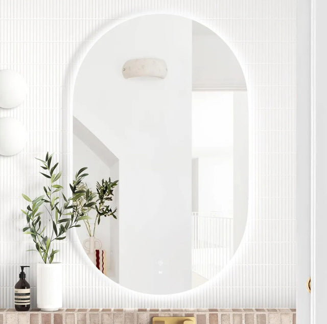 Round mirror on a white wall with decorative elements