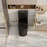 A matte black ceramic toilet centered in a modern bathroom with white and gray marble tiles, a marble vanity, and small toiletries on a shelf.