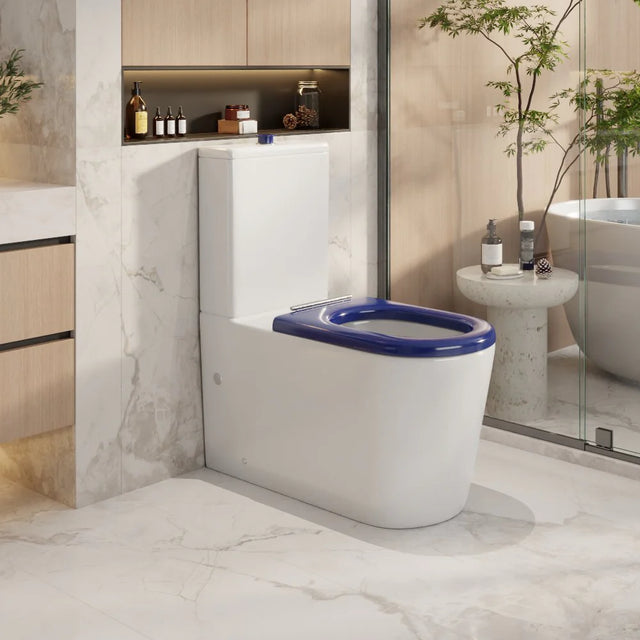 Modern bathroom with a white toilet and blue seat cover.