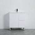 White bathroom vanity with sink against a gray wall