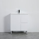 White bathroom vanity with sink against a gray wall