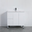 White bathroom vanity with a sink on a gray floor against a white wall