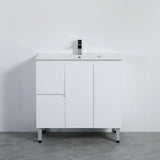 White bathroom vanity with a sink on a gray floor against a white wall