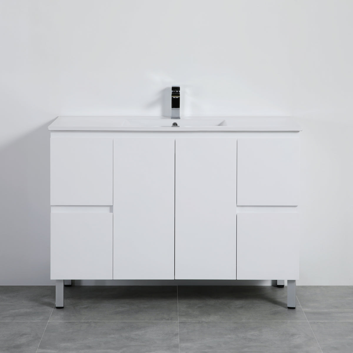 White bathroom vanity with a mirror on a gray floor and white wall