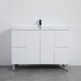White bathroom vanity with a mirror on a gray floor and white wall