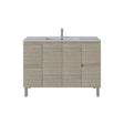 A modern bathroom vanity cabinet with a light oak wood grain finish, featuring a white integrated sink and a tall chrome faucet, set against a plain white background.
