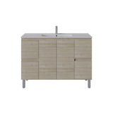 A modern bathroom vanity cabinet with a light oak wood grain finish, featuring a white integrated sink and a tall chrome faucet, set against a plain white background.