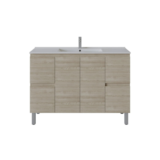 A modern bathroom vanity cabinet with a light oak wood grain finish, featuring a white integrated sink and a tall chrome faucet, set against a plain white background.