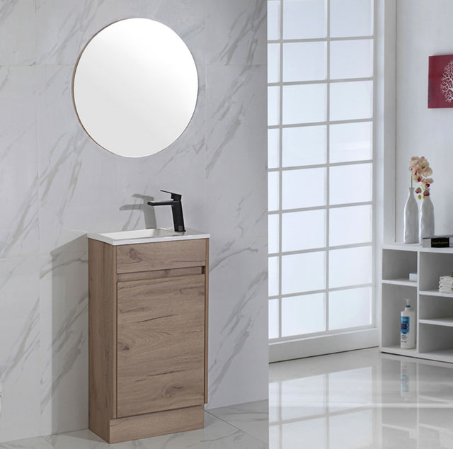 Bathroom with wooden vanity, round mirror, and marble walls