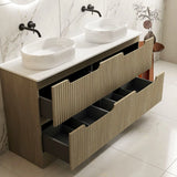 Bathroom vanity with two white sinks and multiple drawers in a modern bathroom setting.
